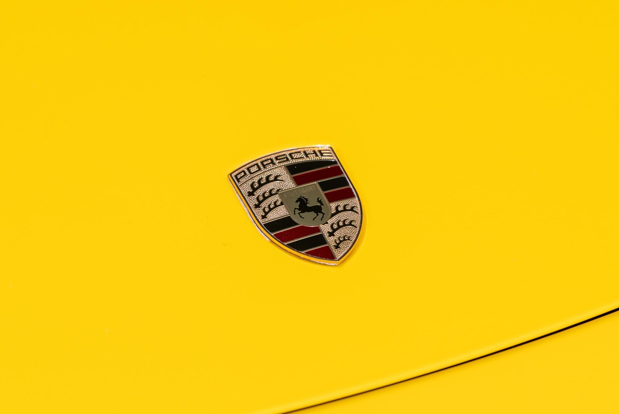 carsandbids.com - porsche, logo, emblem, badge, yellow